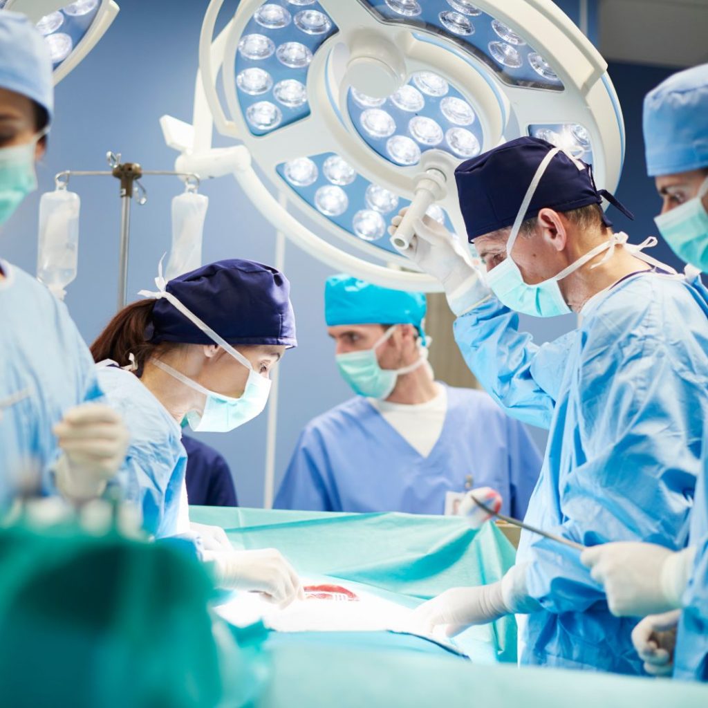 Operating room with doctors and nurses working on a patient